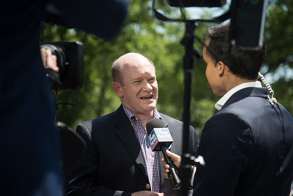 Delaware Senator Christ Coons  speaks to the media.