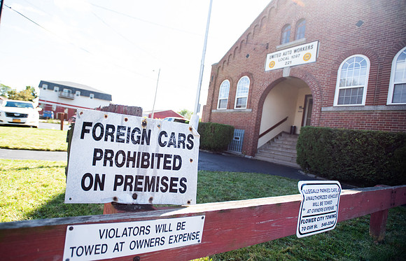 A sign outside of the UAW 1097 union hall 'prohibits' foreign cars from parking there.