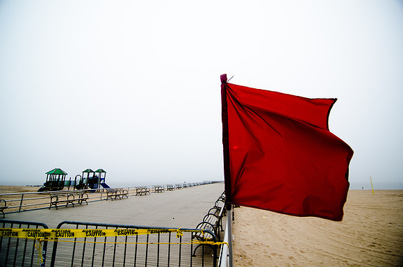Red warning flags fly at Coney Island before Hurricane Irene hits.