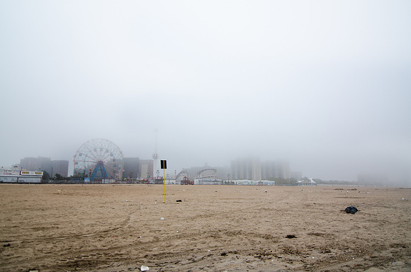 A man sleeps off the previous night on the Coney Island Beach - as Hurricane Irene gets closer.